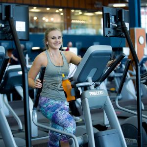 photo of woman using the elliptical