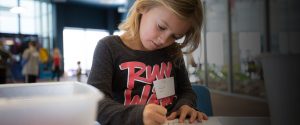 photo of young girl coloring in kids club area