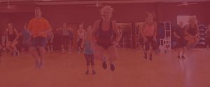 photo of an instructor teaching a fitness class - photo has a red overlay