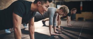 picture of three people doing push-ups