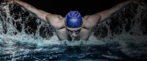 artistic photo of swimmer doing the breast stroke