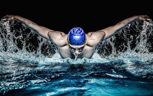 artistic photo of swimmer doing breast stroke