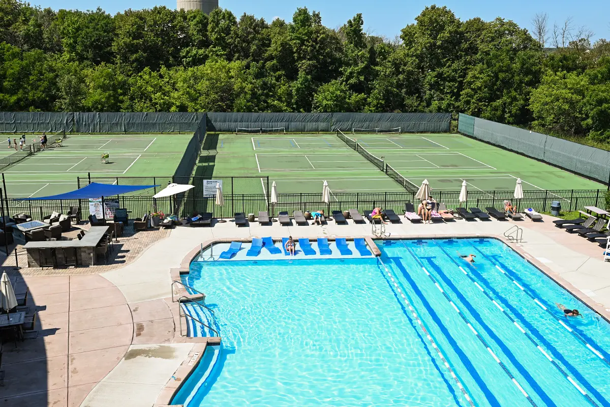 an outdoor pool and tennis courts